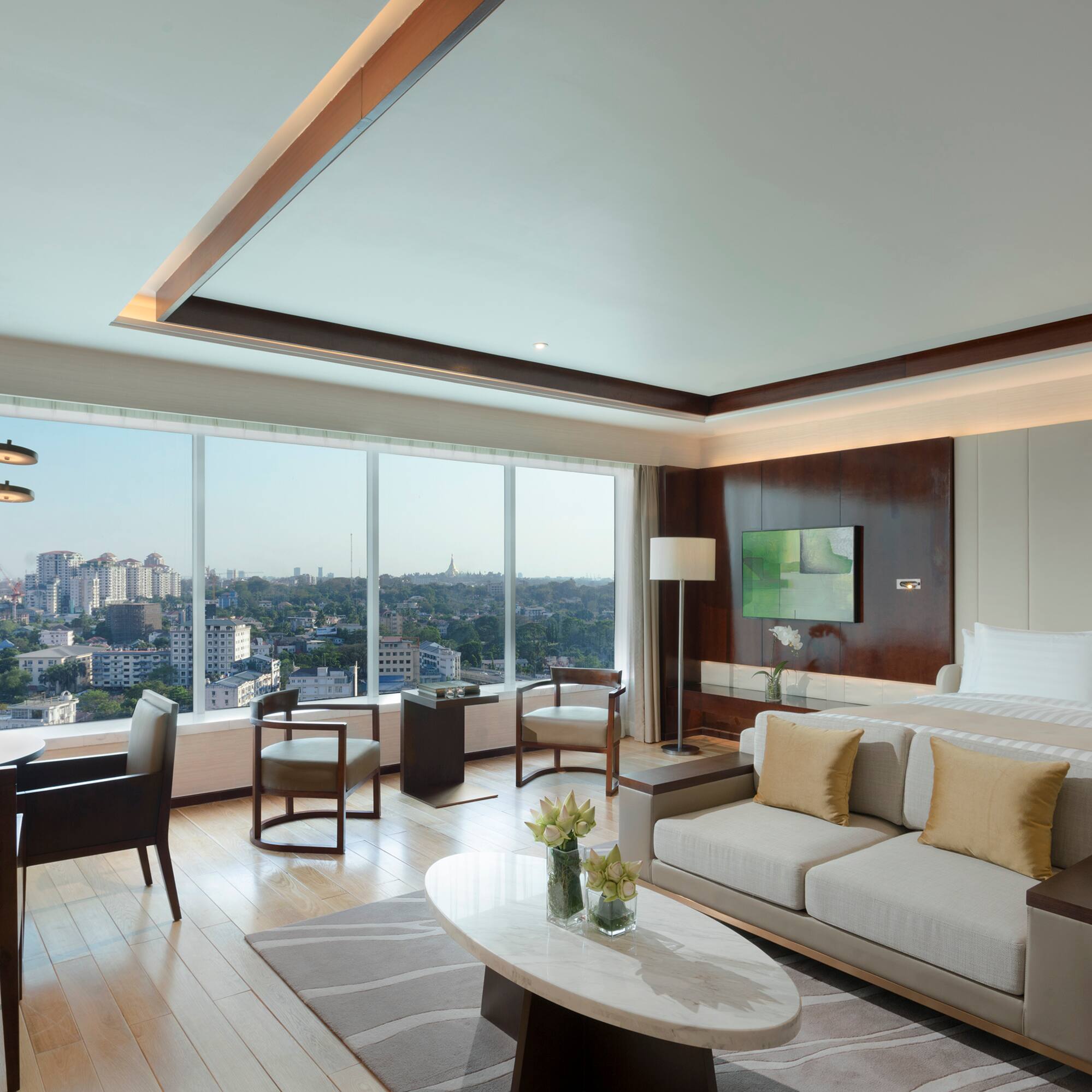 a room with a bed and a table and chairs