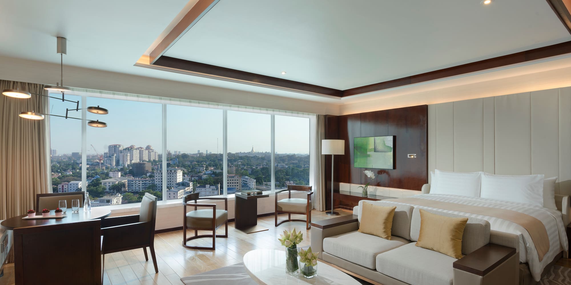 a room with a bed and a table and chairs