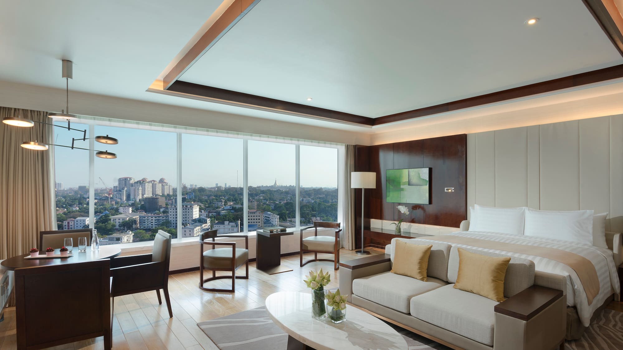 a room with a bed and a table and chairs