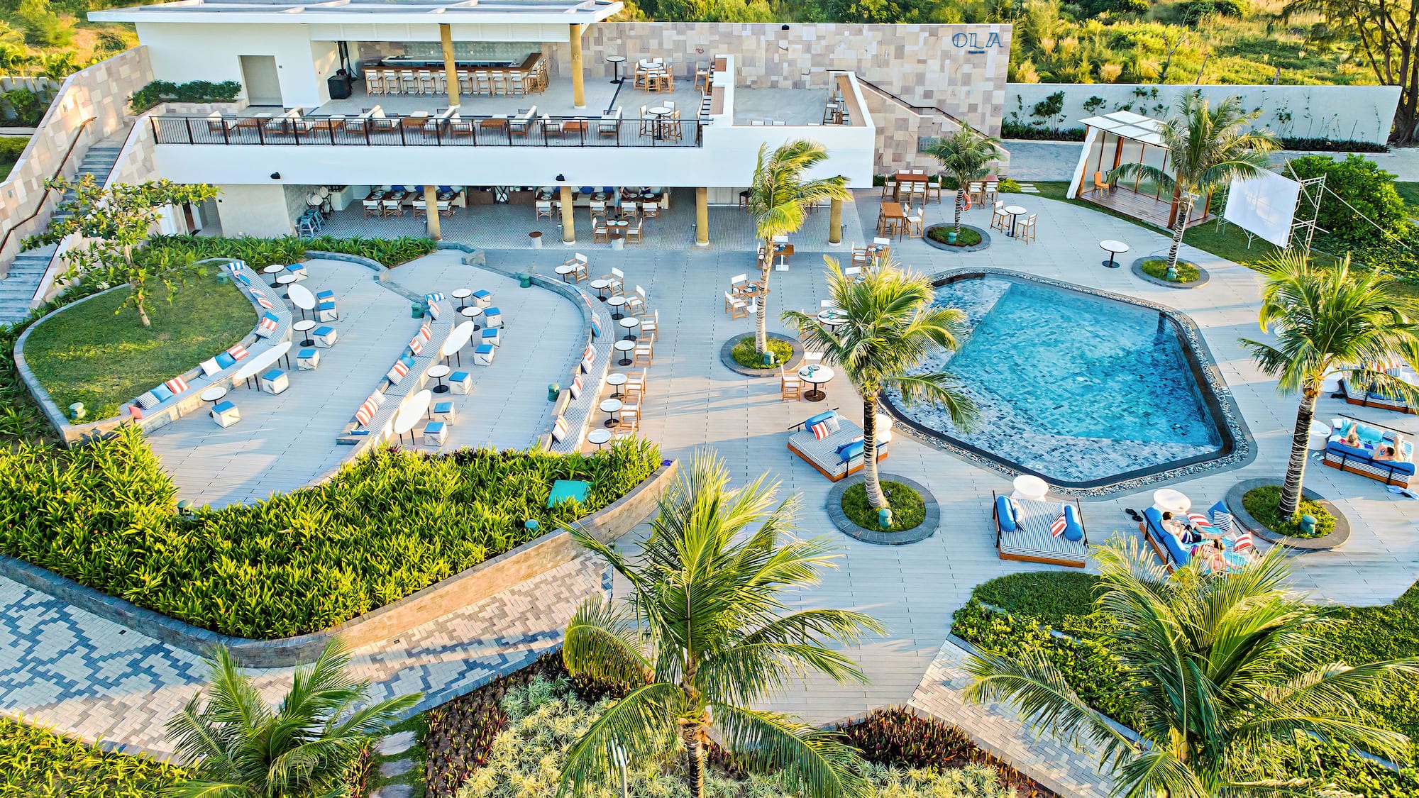 a pool and palm trees with chairs and tables