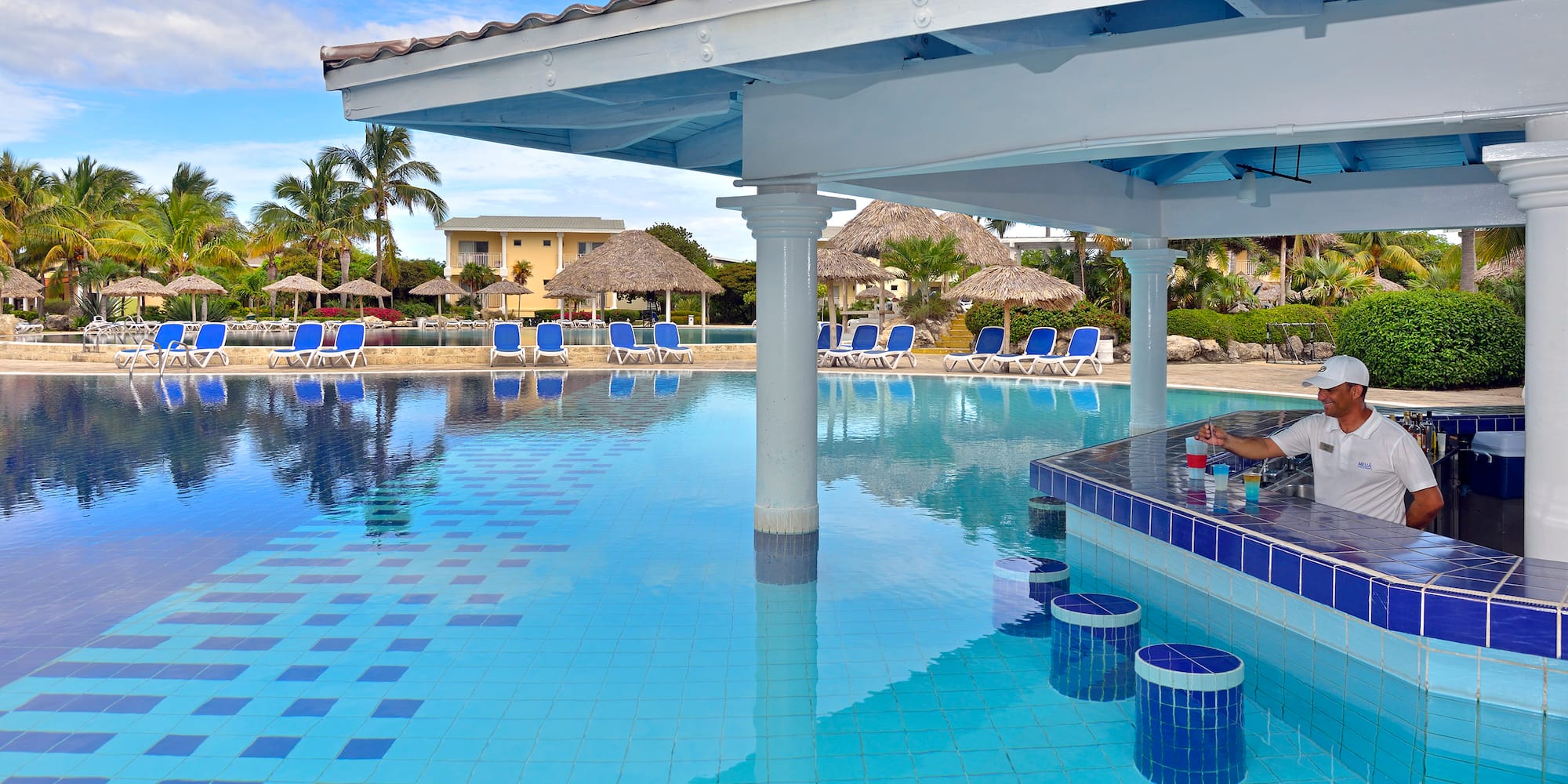 a pool with a bar and chairs