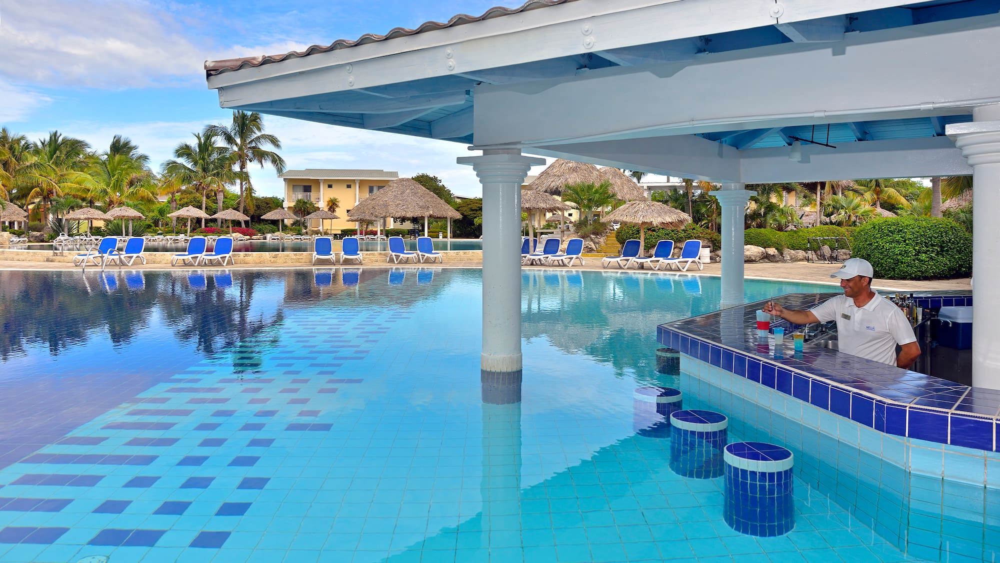 a pool with a bar and chairs
