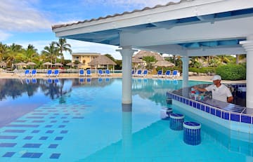 a pool with a bar and chairs