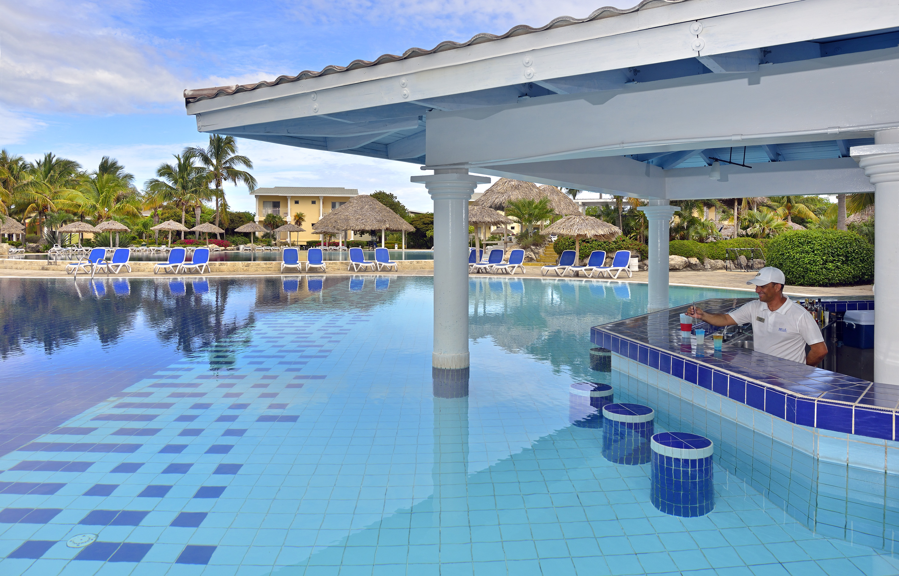 a pool with a bar and chairs