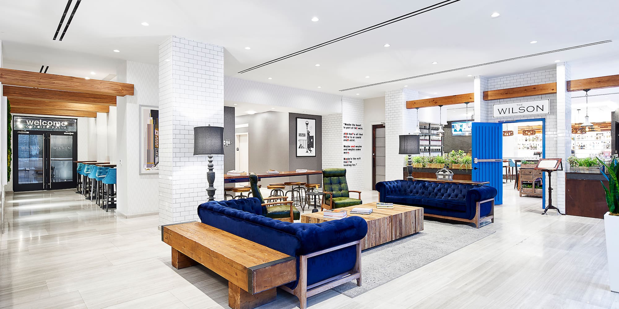 a room with blue couches and wood tables