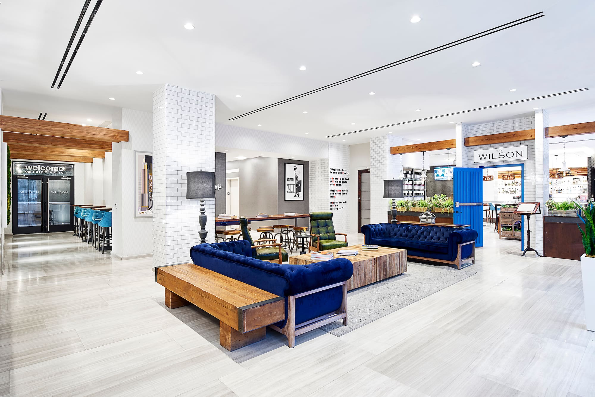 a room with blue couches and wood tables