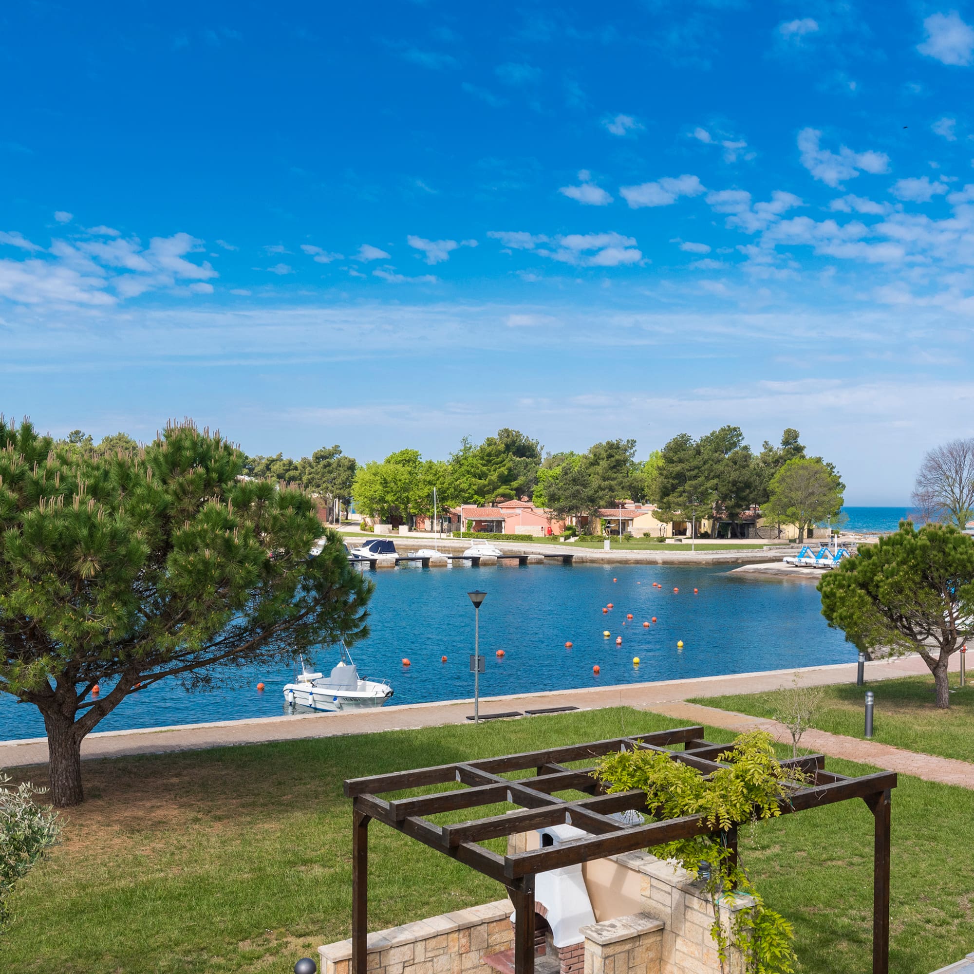 a view of a body of water and a park with trees and a boat dock