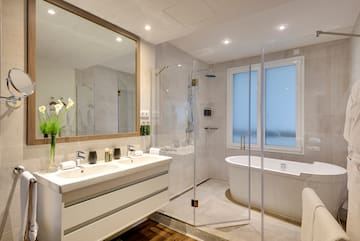 a bathroom with a tub and a shower