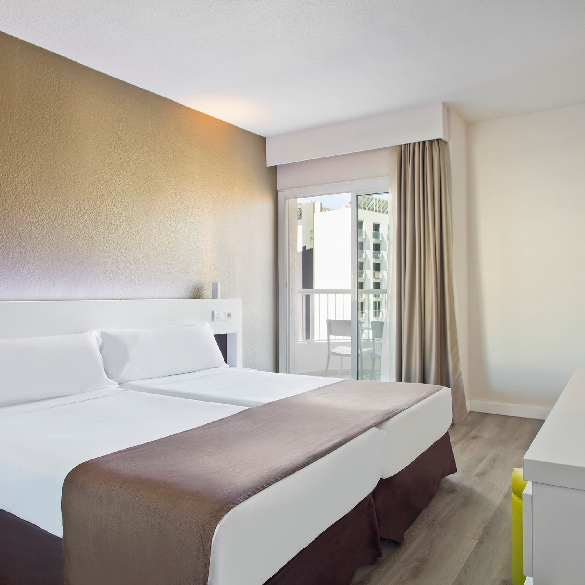 a room with two beds and a window