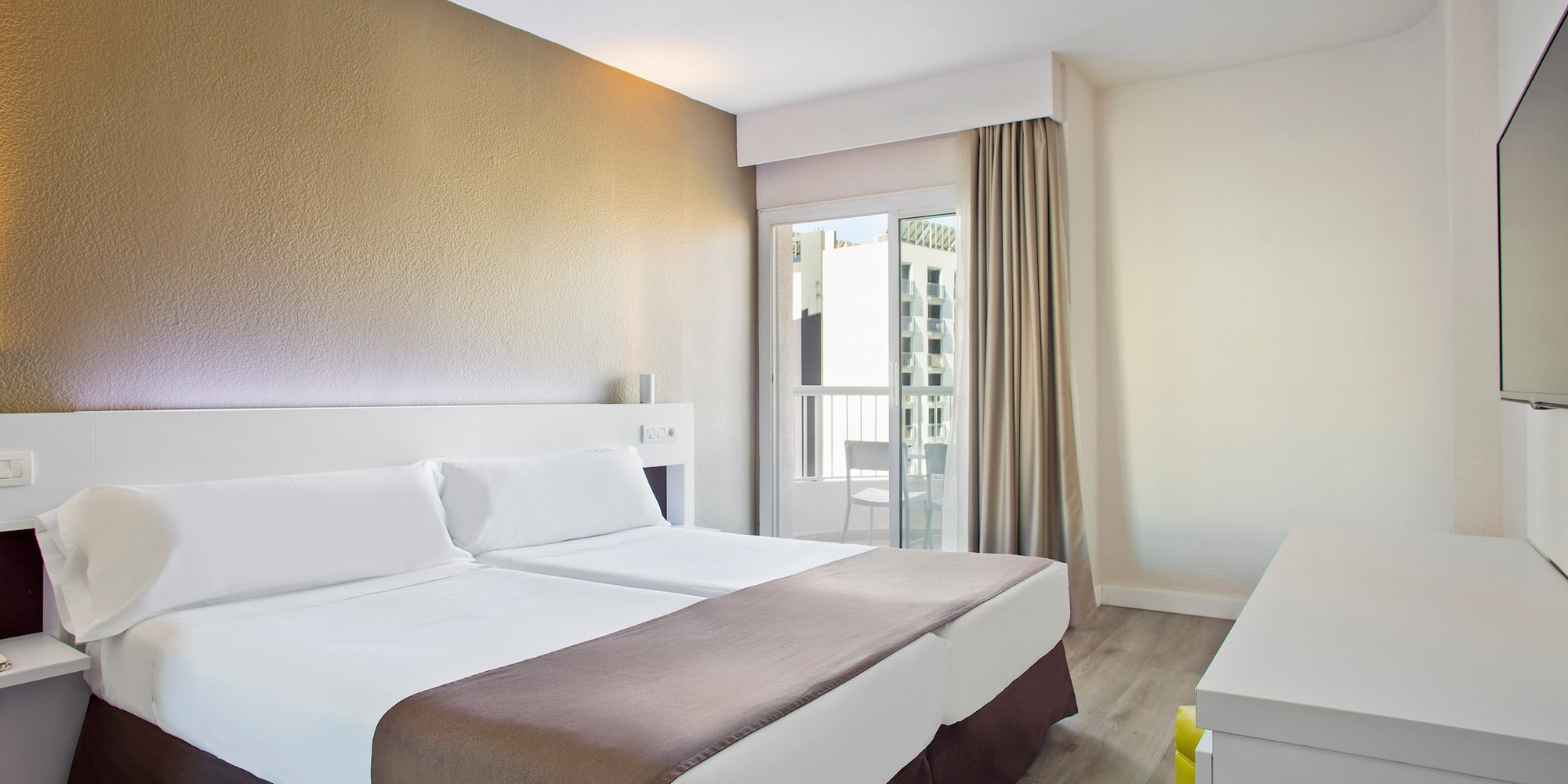 a room with two beds and a window