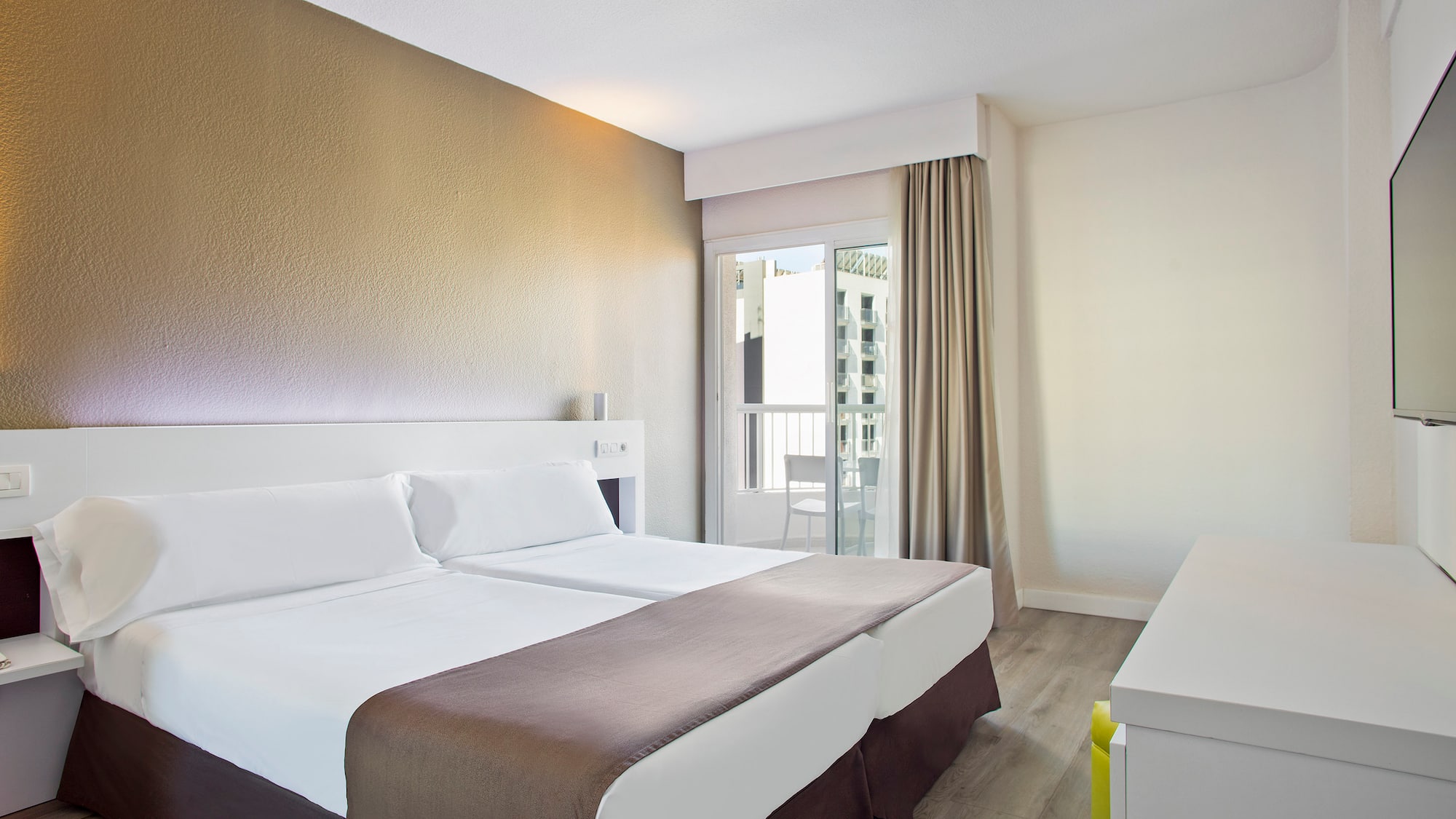 a room with two beds and a window