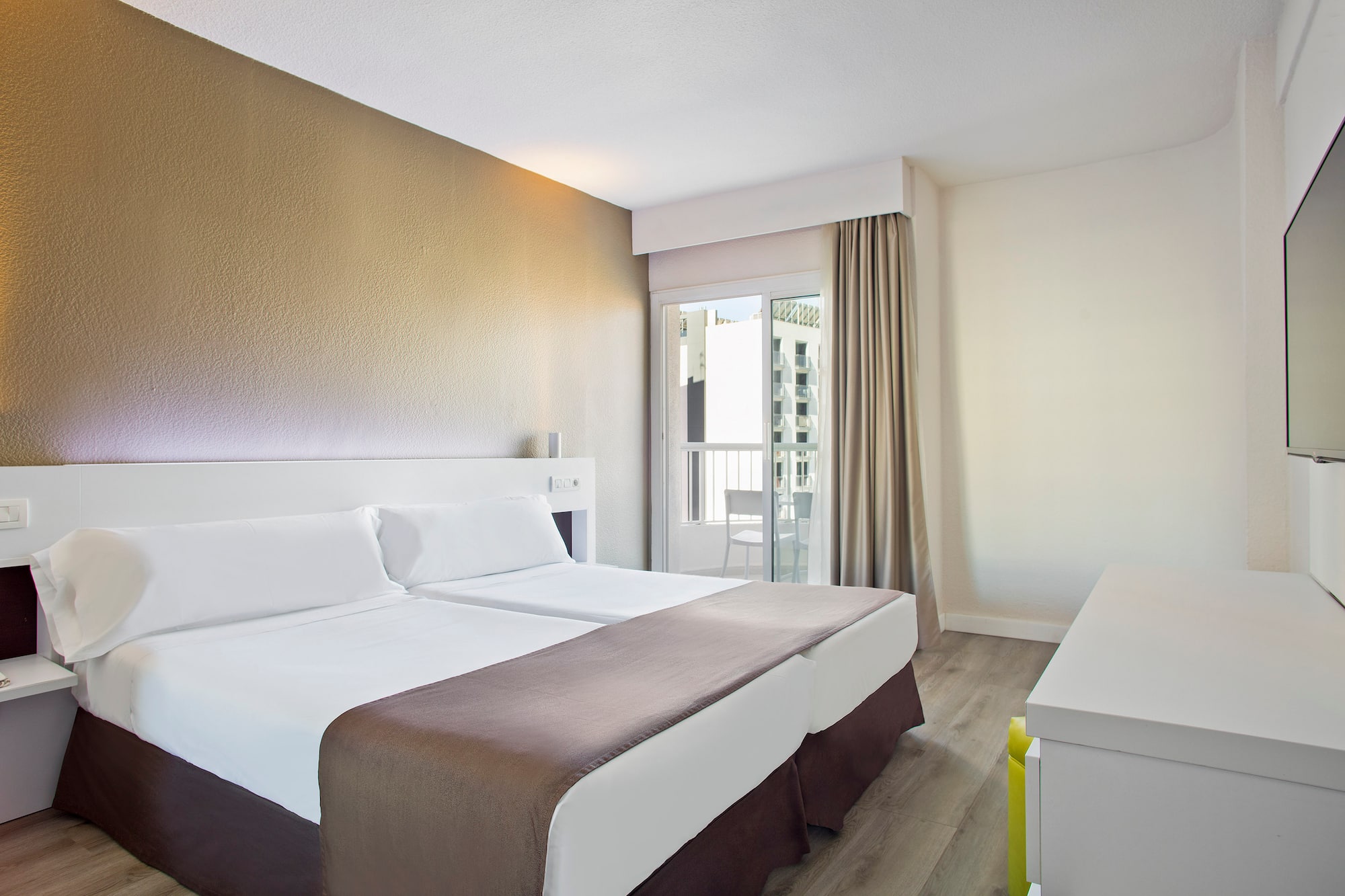 a room with two beds and a window