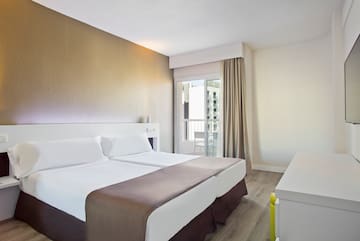 a room with two beds and a window