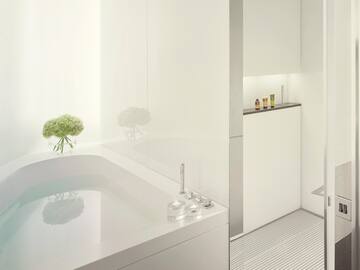 a white bathroom with a bathtub and shower