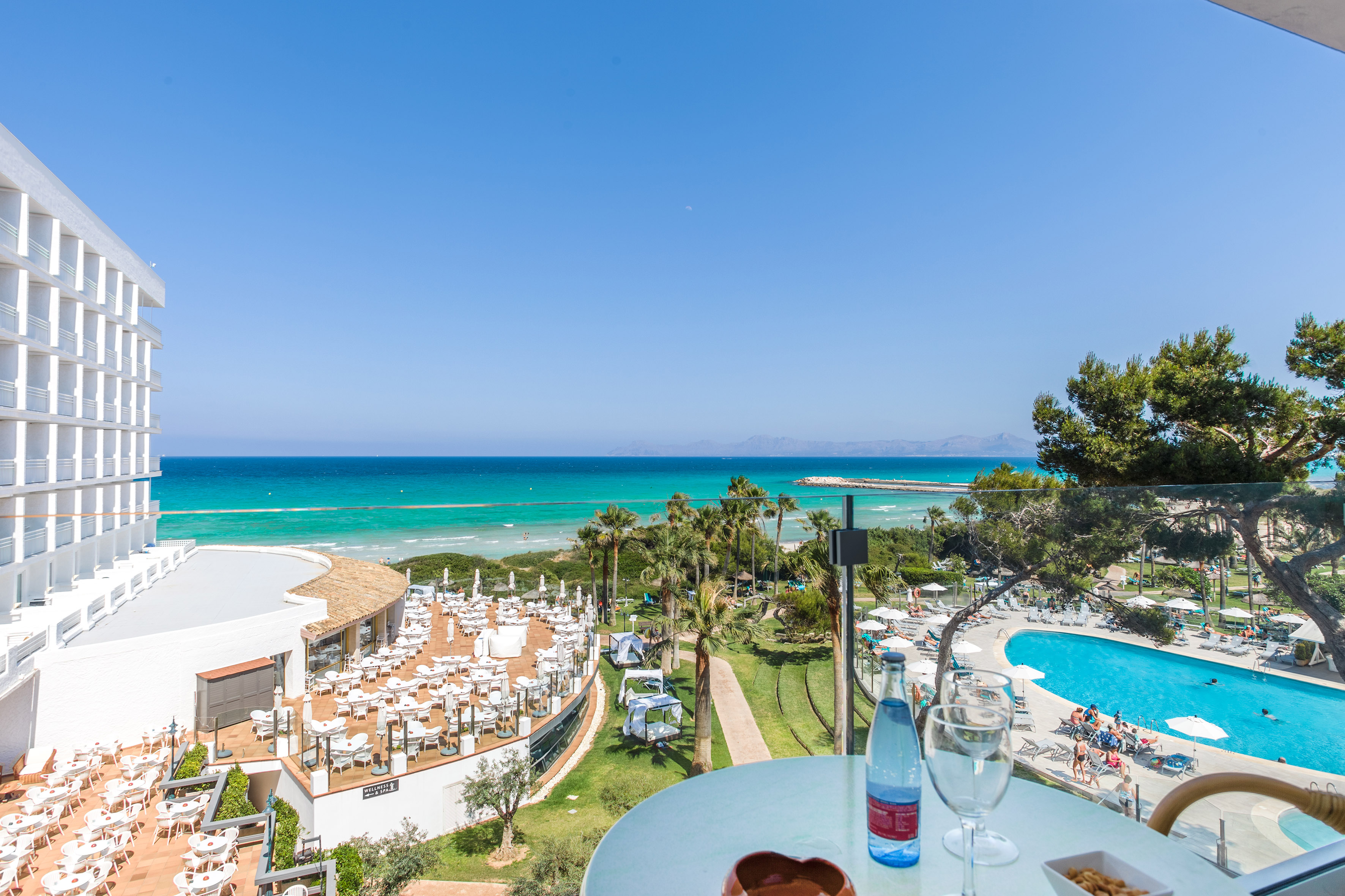 a table with food and a pool in the background