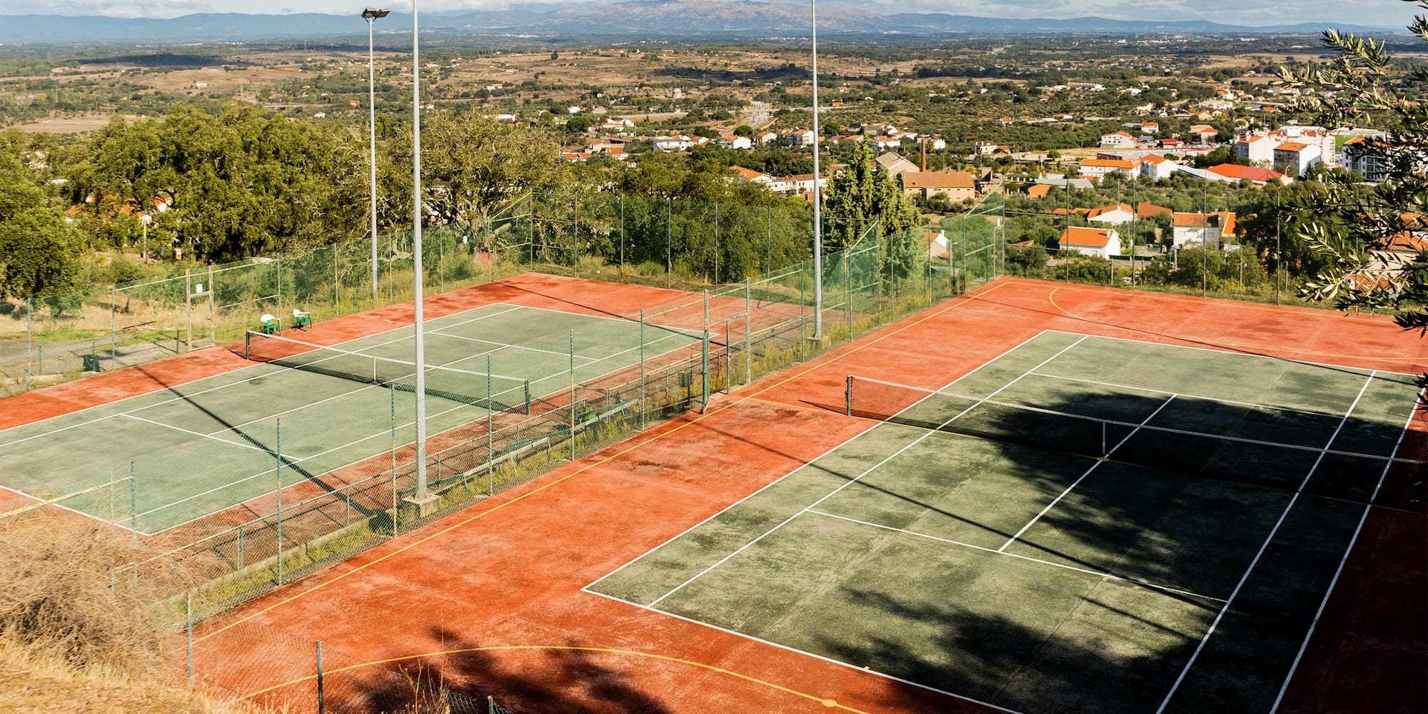 a tennis court with a view of a city