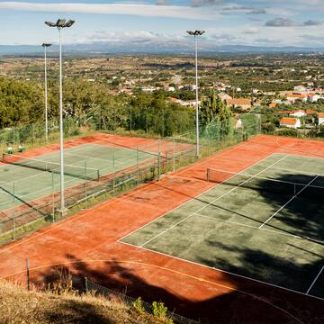 a tennis court with a view of a city
