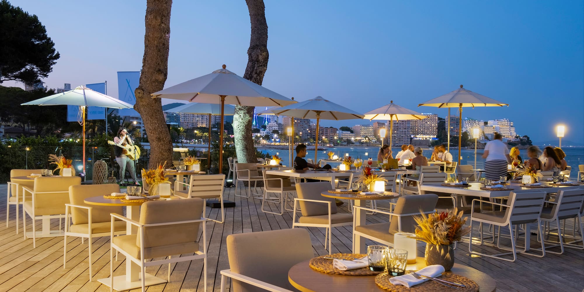 a outdoor restaurant with tables and umbrellas