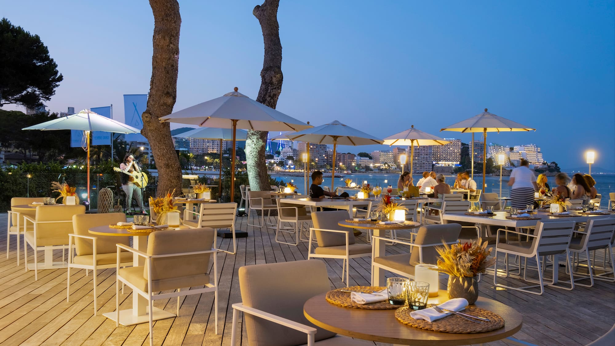 a outdoor restaurant with tables and umbrellas