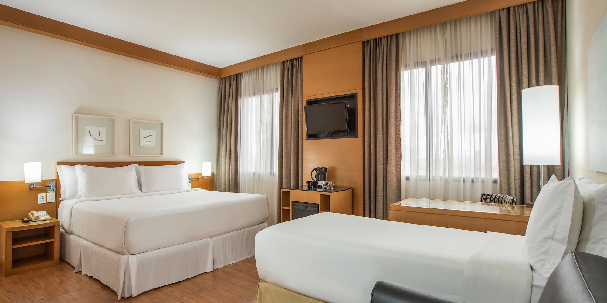 a room with two beds and a tv