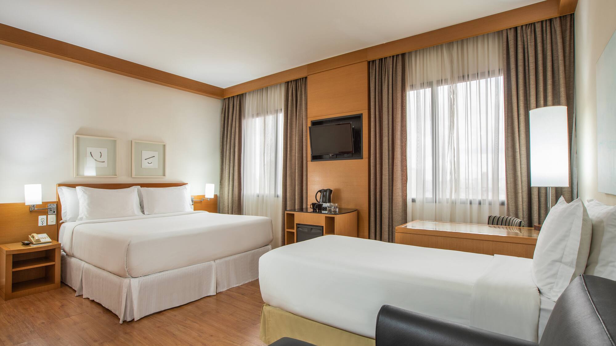 a room with two beds and a tv