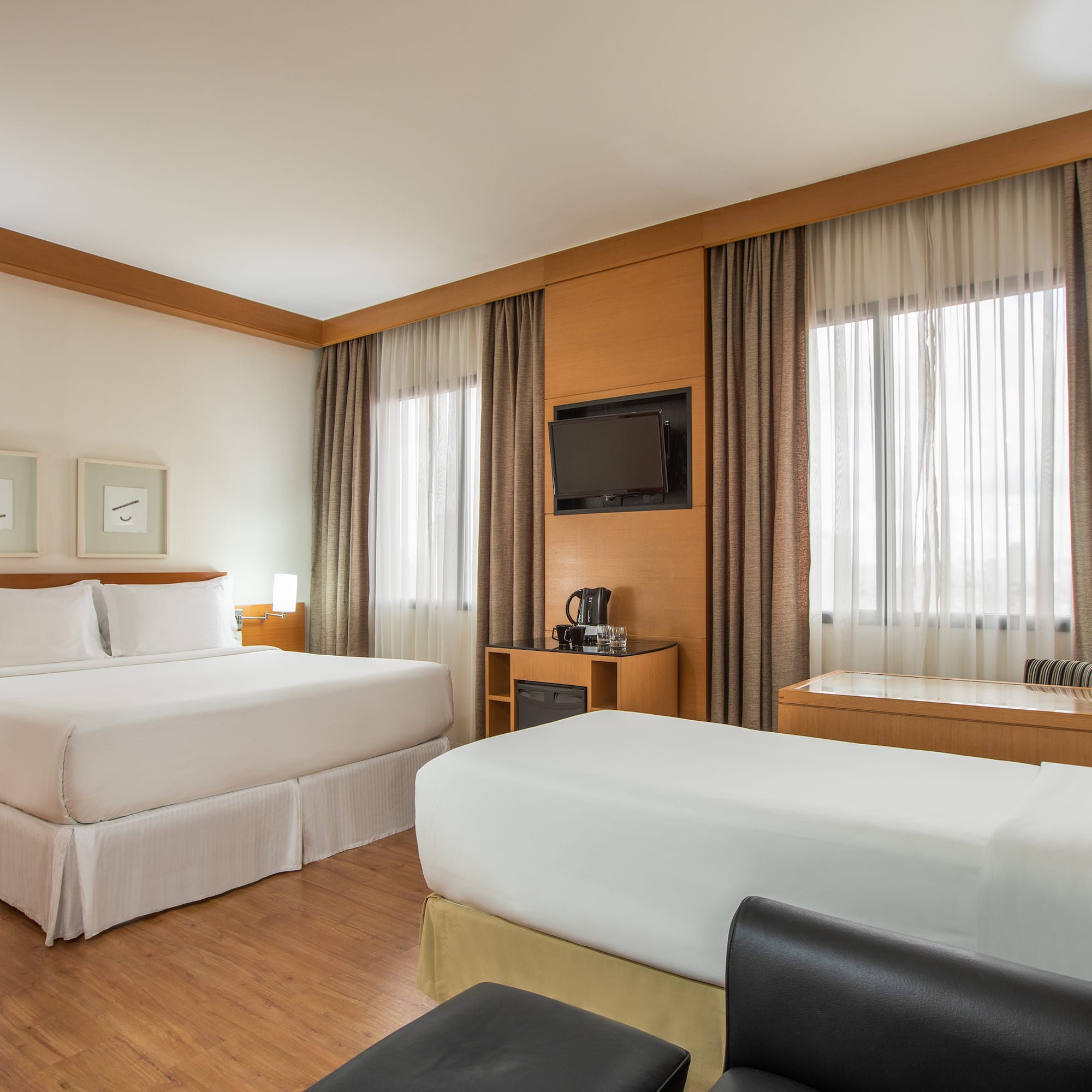 a room with two beds and a tv