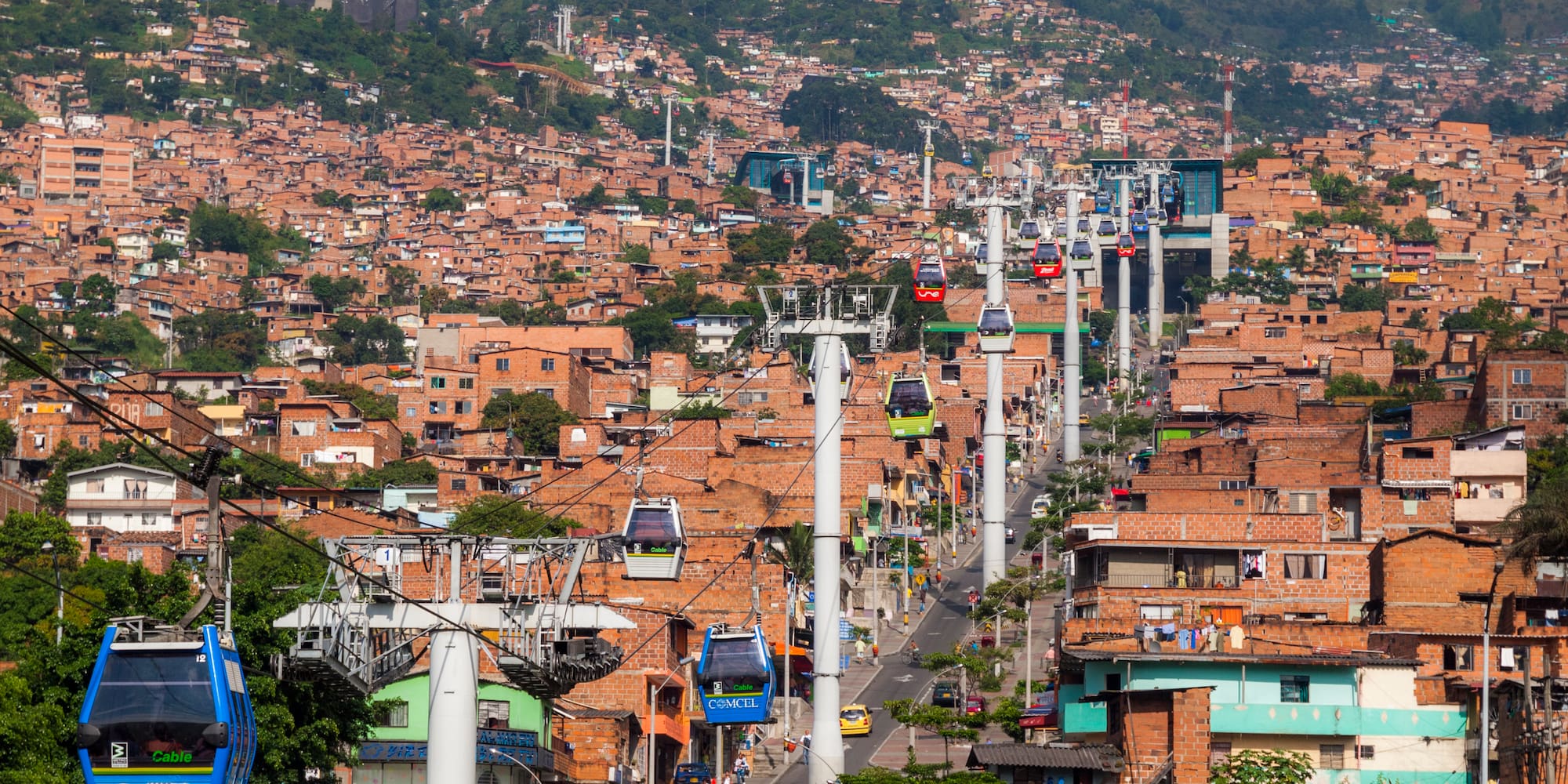 a city with buildings and cable cars