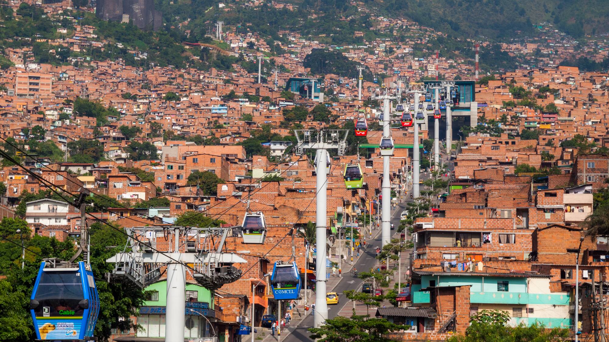 a city with buildings and cable cars