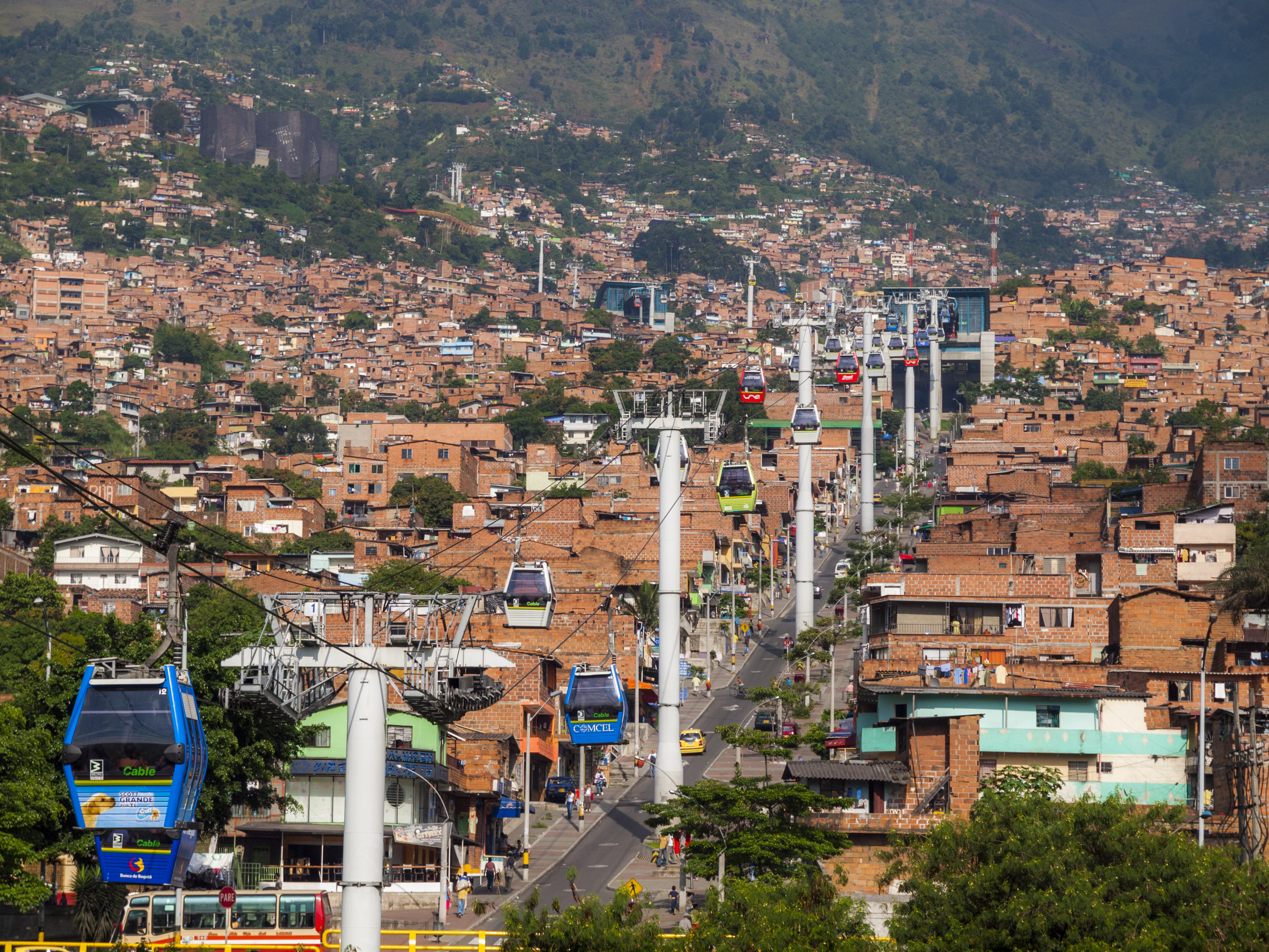 a city with buildings and cable cars