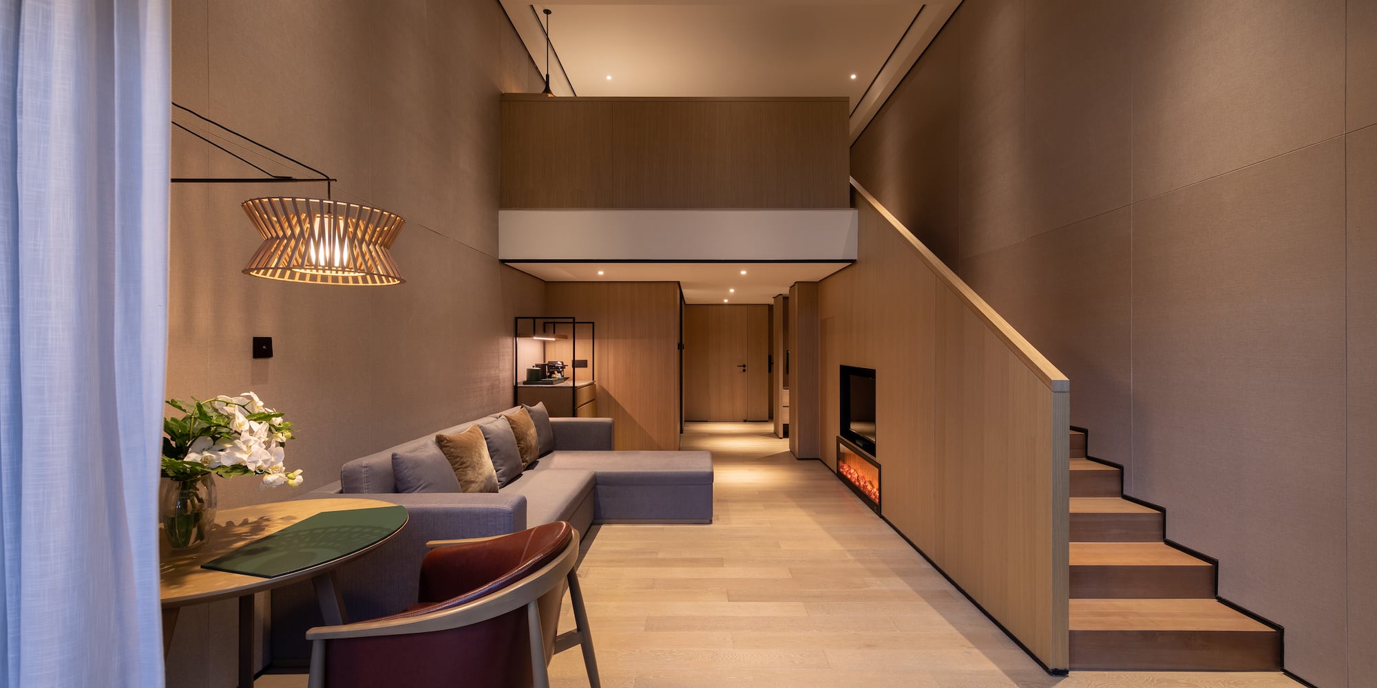 a living room with a couch and a staircase