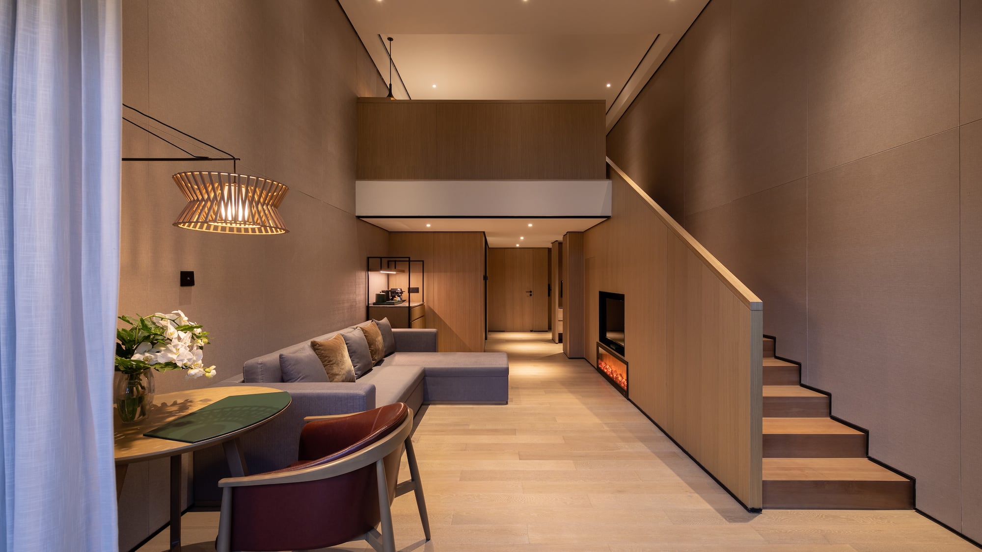 a living room with a couch and a staircase