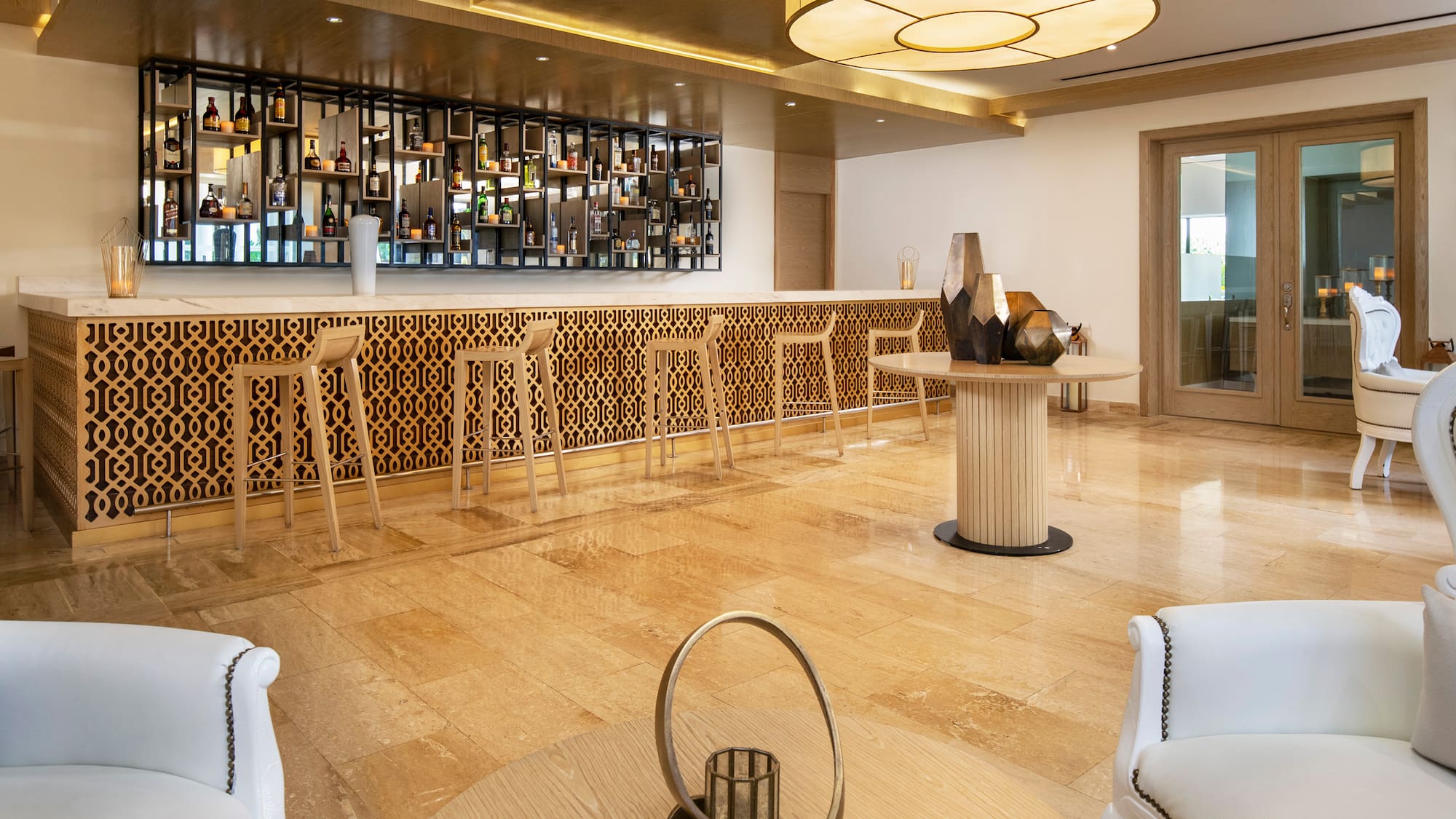 a room with a bar and a shelf with bottles