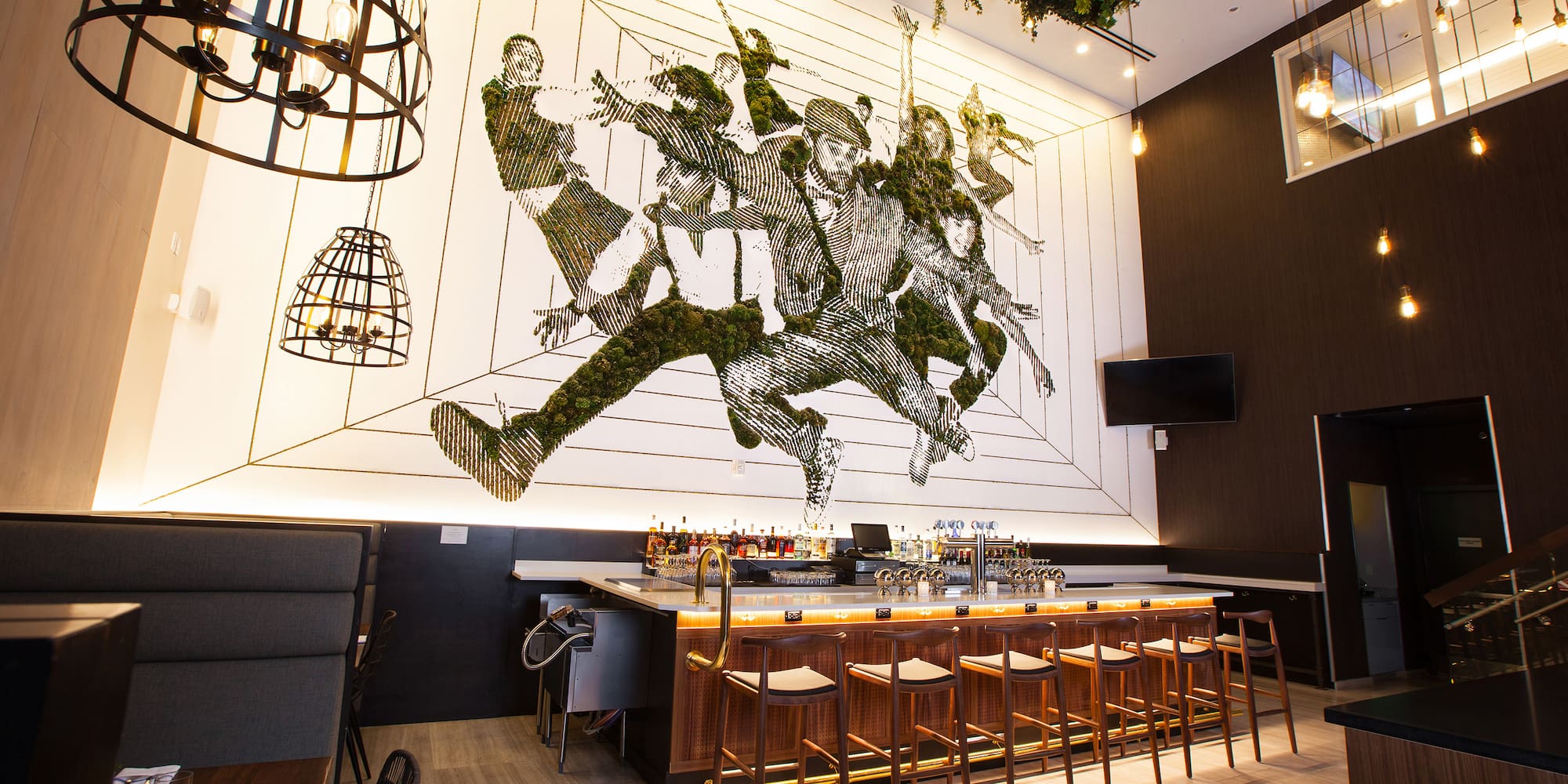 a bar with a painting on the wall