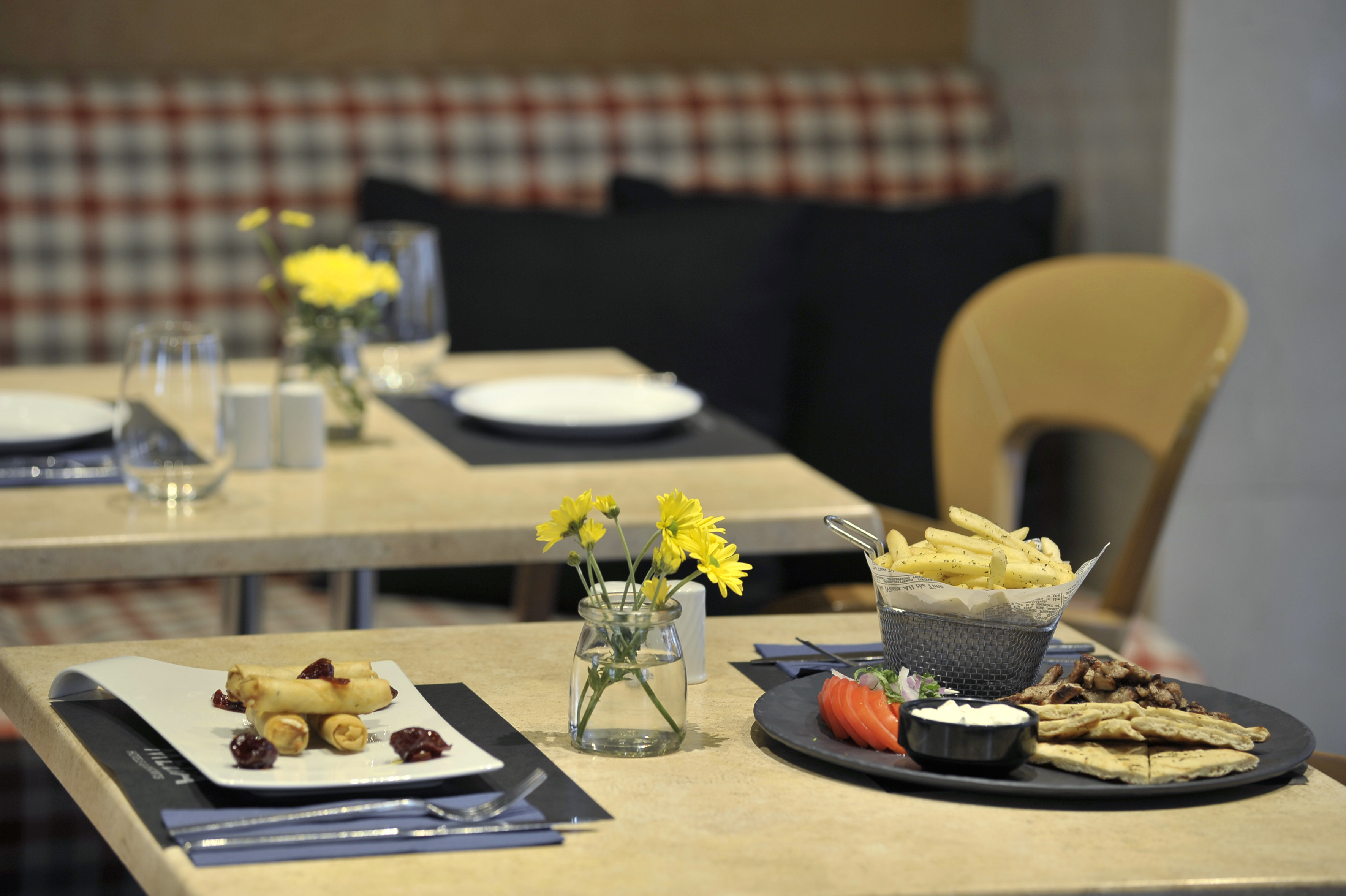 a table with plates of food and flowers