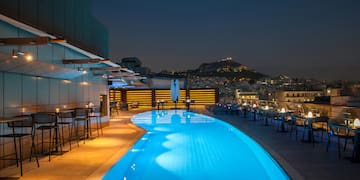 a pool with chairs and tables around it