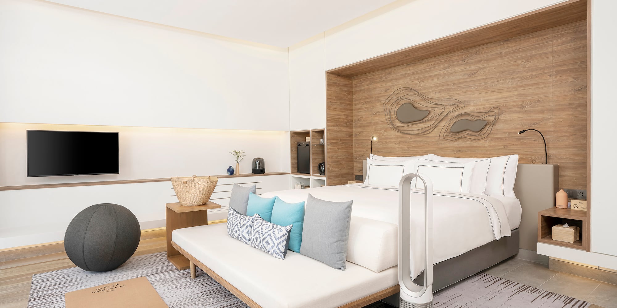 a room with a bed and a television