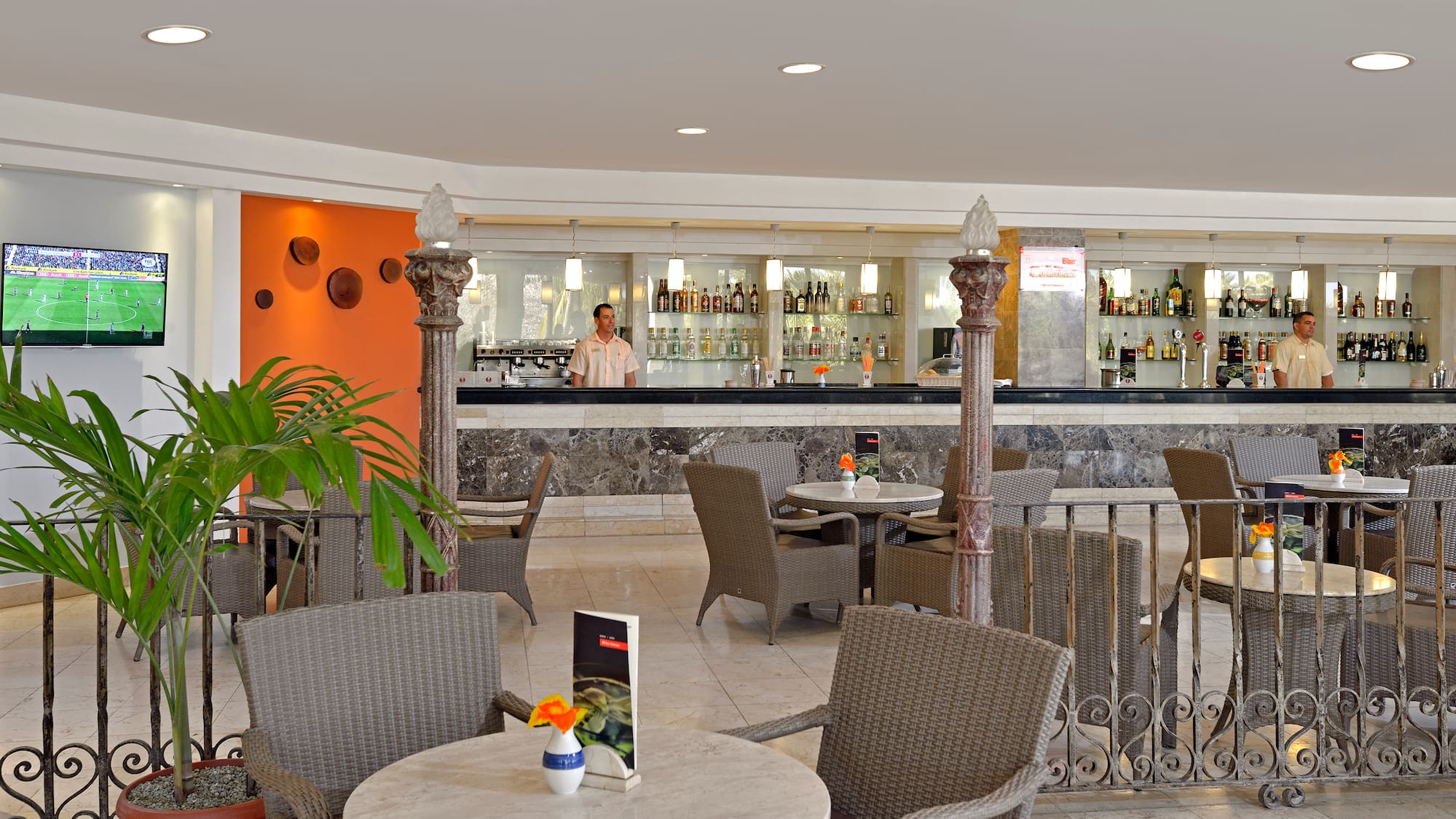 a man standing behind a bar