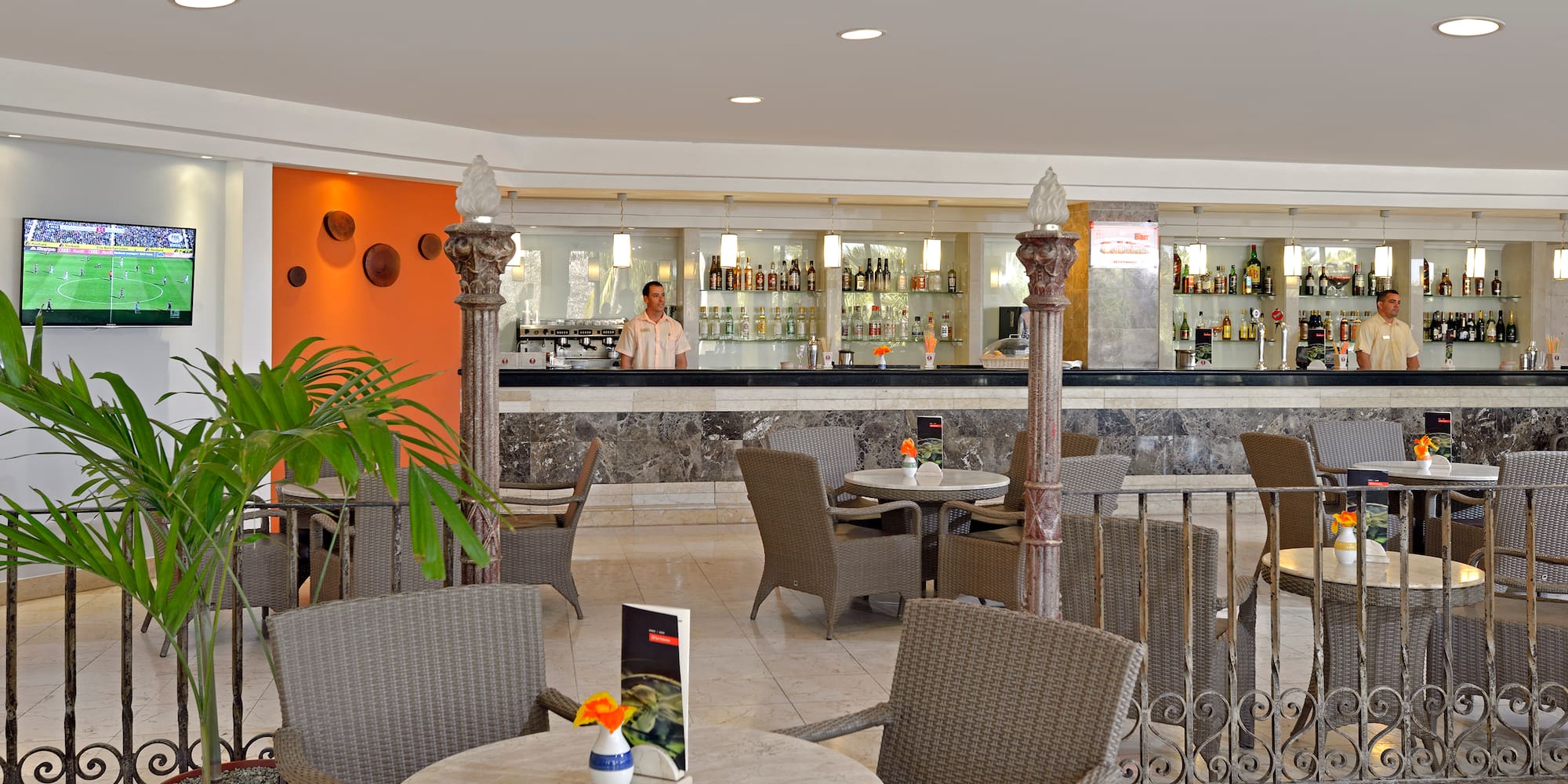 a man standing behind a bar