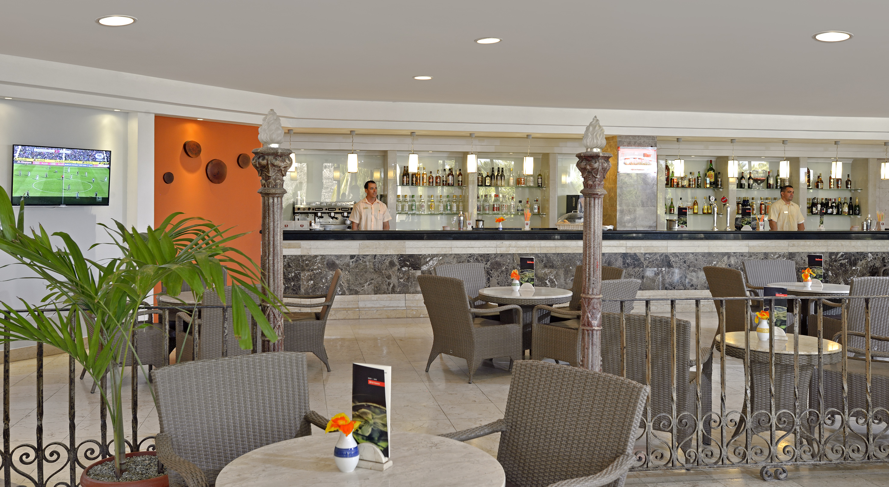 a man standing behind a bar