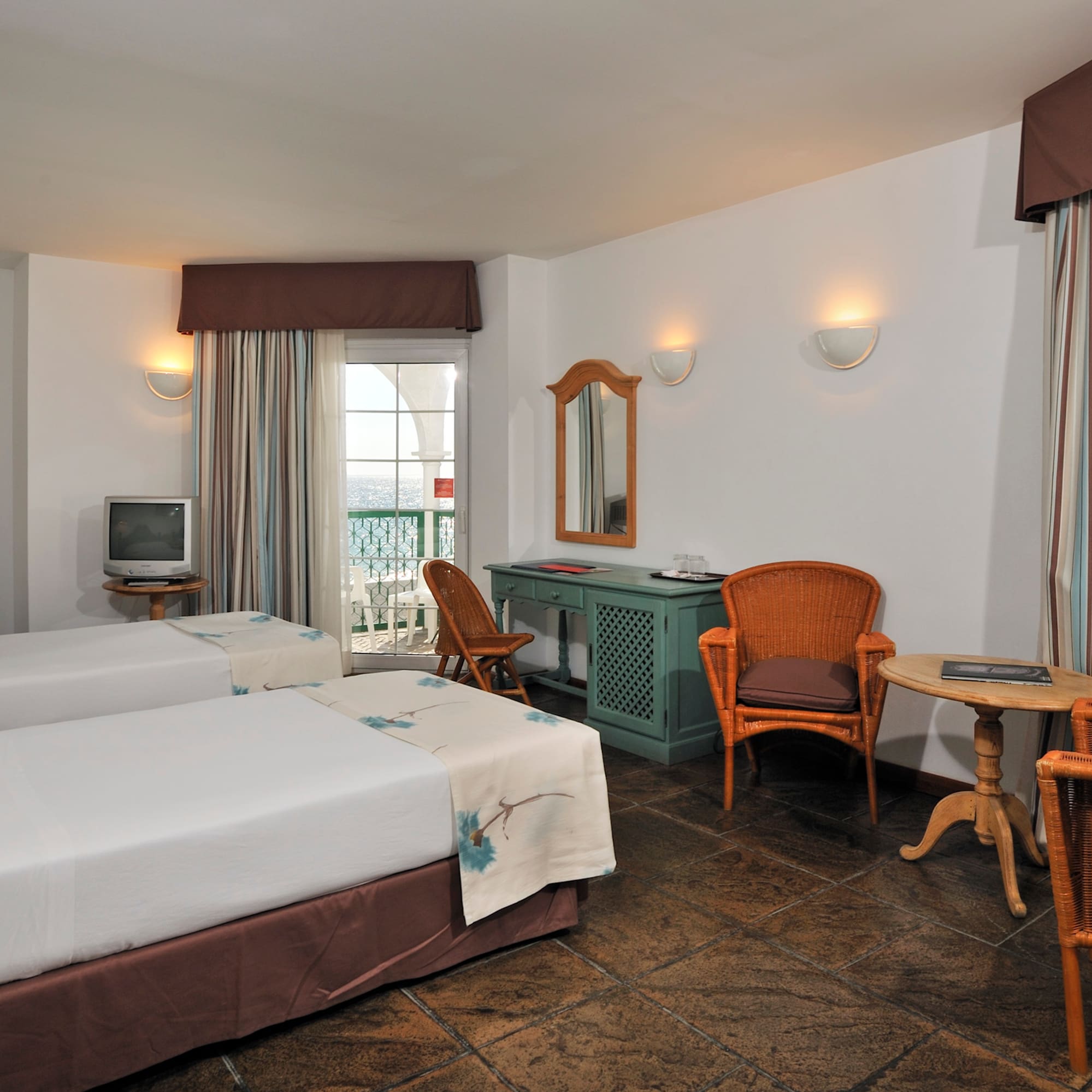 a room with two beds and a table