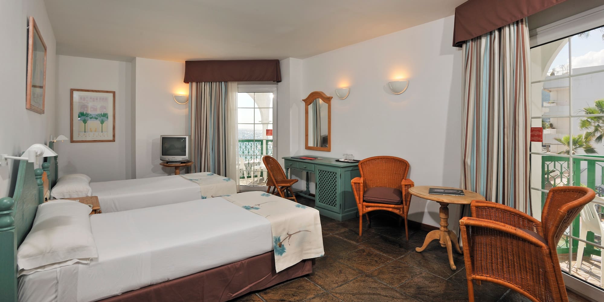 a room with two beds and a table