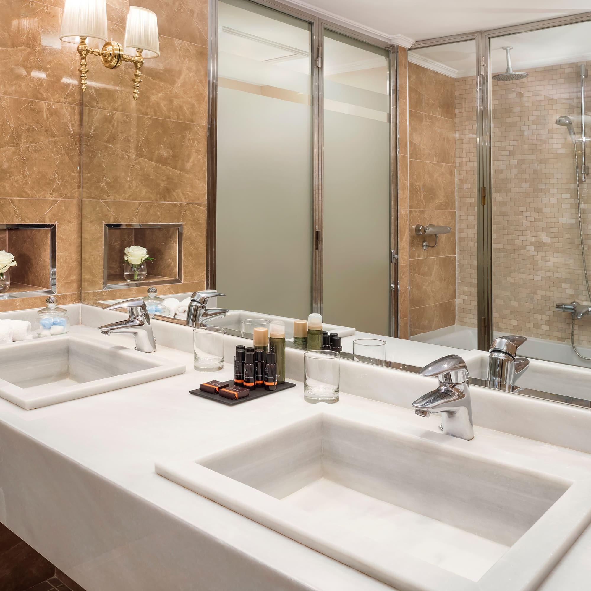 a bathroom with marble counter tops and sinks