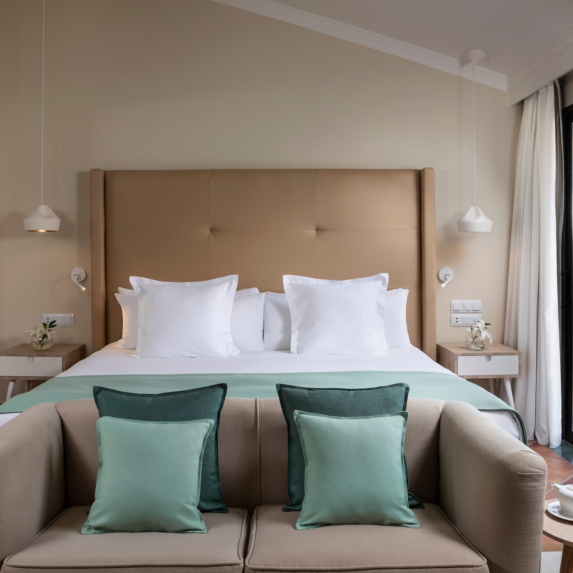 a bed with pillows and a couch in a room