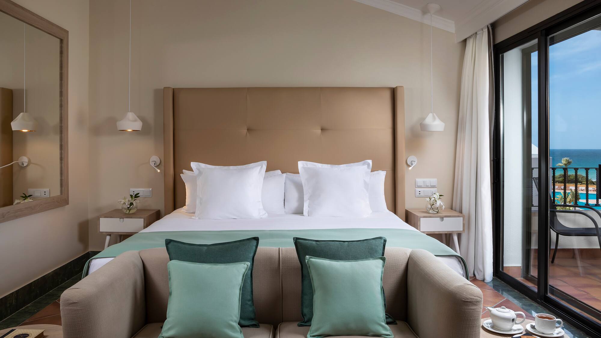 a bed with pillows and a couch in a room