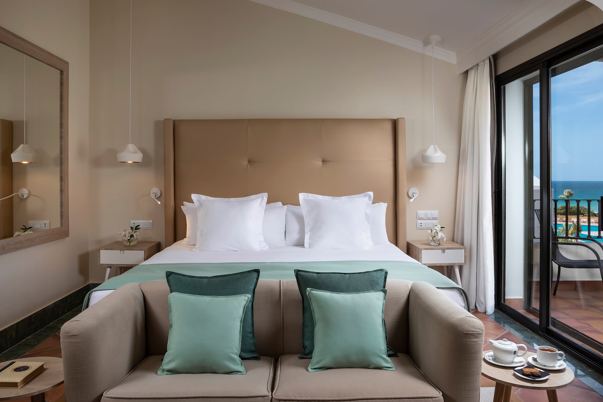 a bed with pillows and a couch in a room