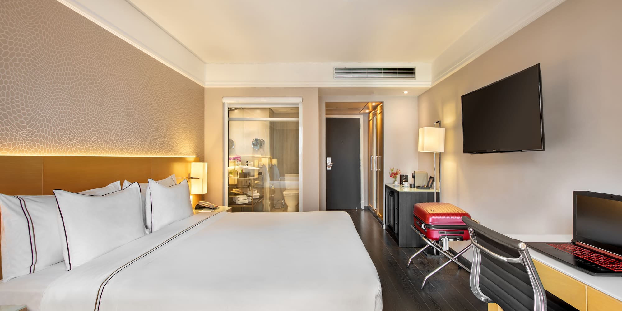 a hotel room with a bed and a television