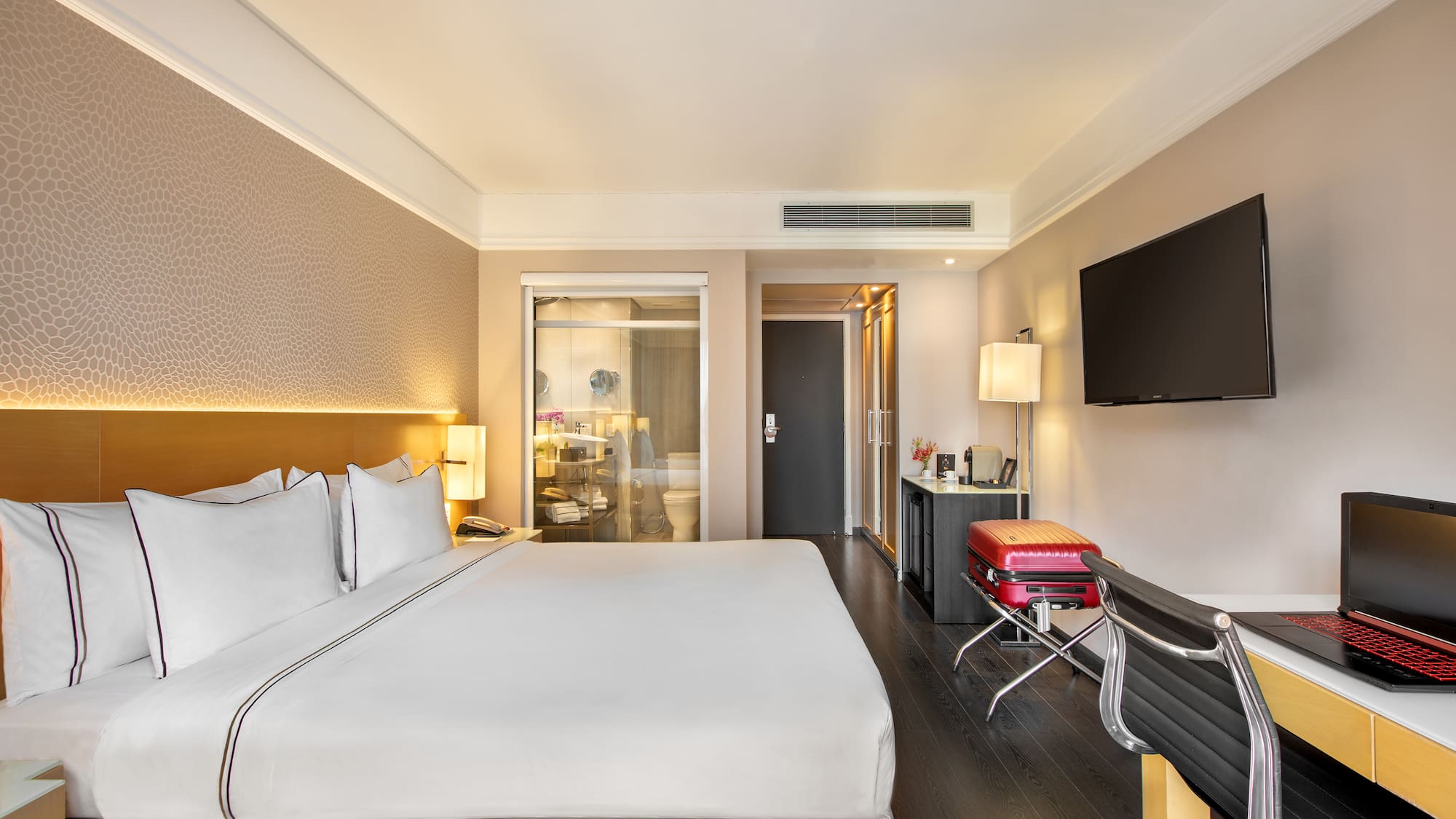 a hotel room with a bed and a television