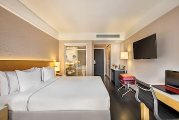 a hotel room with a bed and a television