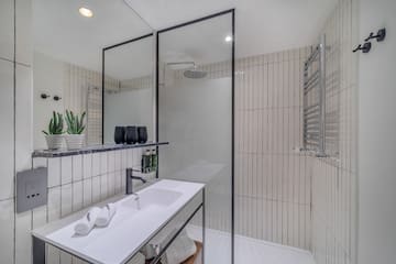 a bathroom with a shower and sink