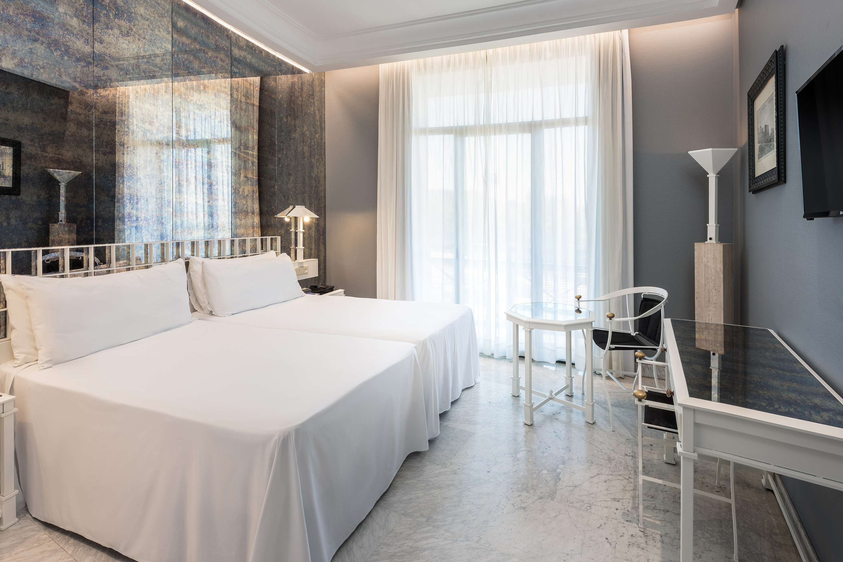 a room with two beds and a piano